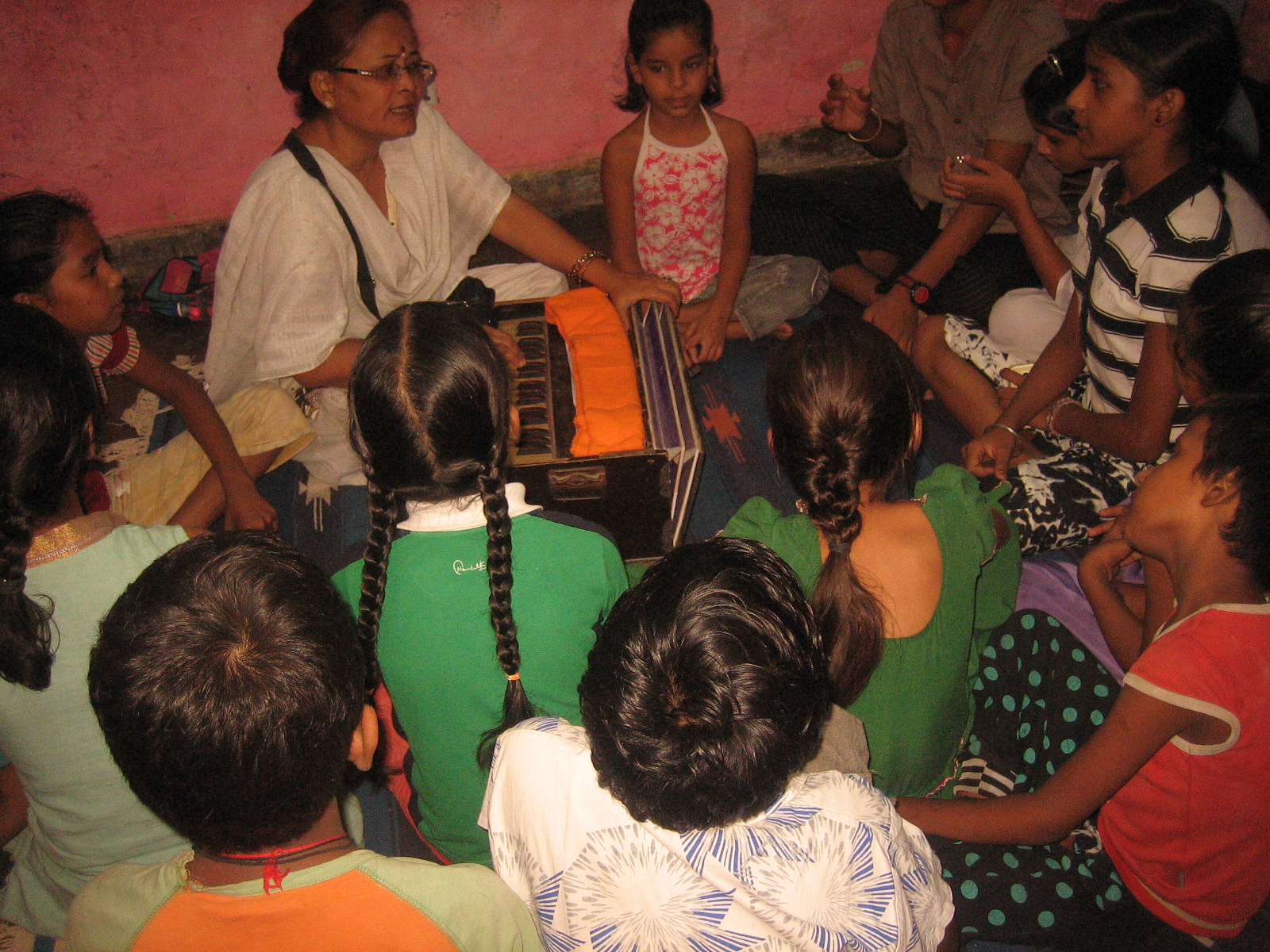 Teacher conducting a music session with children at Prajna Foundation